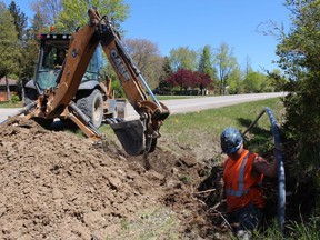 Brandon Keller, right, with Weber Construction, works on installation of fibre-optic cable along Lakeshore Road in Plympton-Wyoming. Several projects worth $17.6 million are underway across Lambton County that will bring higher speed broadband to about 4,500 residents and businesses.