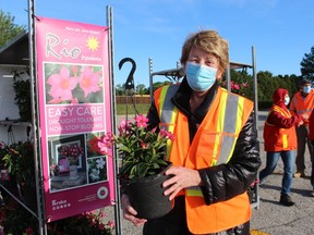 Dianne McKillican, with Rayjon Share Care, holds one of the plants still available Saturday at this year's DeGroots-Rayjon plant sale in Sarnia. The annual fundraiser began 14 years ago.