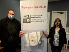 Fanny Belcoski, right, and Rev. Peter Ciallella inside the newly opened Centre for Migrant Worker Solidarity in Simcoe, a resource centre and gathering spot for migrant farm workers in Norfolk County. Among the centre's first projects is to fill and distribute welcome bags filled with toiletries, snacks and personal protective equipment, as well as information about workers' employment and health rights.