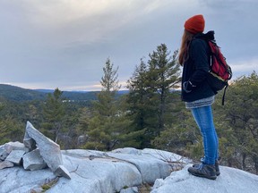 Alyssa Short gazes west from an outcrop on the Heaven's Gate Trail near Willisville in late March. This area has now been protected by the Escarpment Biosphere Conservancy.