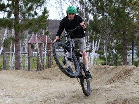 Connor Woods works on his biking skills on a pump track at Kivi Park in Sudbury, Ont. Thursday will be sunny with a high of 20 degrees C. John Lappa/Sudbury Star/Postmedia Network