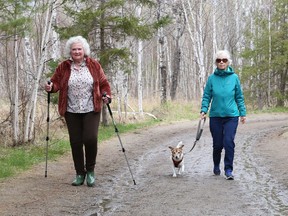 Joanne Fielding, left, and Janet Bradley walk with Cooper on one of the trails at Fielding Memorial Park in Greater Sudbury, Ont. on Thursday May 6, 2021. John Lappa/Sudbury Star/Postmedia Network