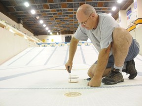 Randy Cavallin, pool operator at the Jeno Tihanyi Olympic Gold Pool at Laurentian University, checks water exhaust ports on the floor of the deep end of the pool in this file photo. The pool has been closed for more than a year. GINO DONATO