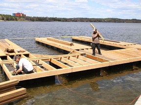 Workers from Floathouse build the base for a floating boathouse on Ramsey Lake in Sudbury, Ont. on Wednesday May 12, 2021. John Lappa/Sudbury Star/Postmedia Network