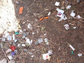 Debris from drug use is scattered near a courtyard gate at the Ukrainian Seniors' Centre in Sudbury, Ont.