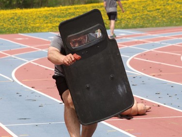Staff-Sgt. Edward Stiller, of the Greater Sudbury Police Emergency Response Unit, takes part in a physical fitness training exercise at the track at Laurentian University in Sudbury, Ont. on Wednesday May 19, 2021. The unit received permission from the university to conduct the exercise and unit members had to sign a waiver. Even during the pandemic, the officers from the unit must take part in the training and meet a specified standard. John Lappa/Sudbury Star/Postmedia Network