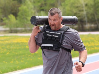 Staff-Sgt. Edward Stiller, of the Greater Sudbury Police Emergency Response Unit, takes part in a physical fitness training exercise at the track at Laurentian University in Sudbury, Ont. on Wednesday May 19, 2021. The unit received permission from the university to conduct the exercise and unit members had to sign a waiver. Even during the pandemic, the officers from the unit must take part in the training and meet a specified standard. John Lappa/Sudbury Star/Postmedia Network