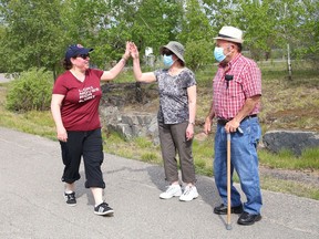 Lori Fiorino, left, who has Multiple Sclerosis, took part in a do-it-yourself fundraising event in support of the Health Sciences North Foundation in Sudbury, Ont. on Thursday May 20, 2021. Fiorino walked around the Delki Dozzi track multiple times on her birthday to raise funds for a second MRI at Health Sciences North. Her parents, Silvia and Luigi, pictured, were on hand to show their support. John Lappa/Sudbury Star/Postmedia Network