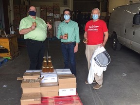 Dan Xilon, executive director of the Sudbury Food Bank (left), receives a donation of honey from Vale's beekeepers, Quentin Smith, a project engineer, and Bob Dewar, a retired teacher. Supplied