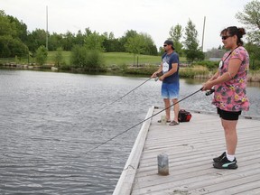 Darrel Kuula and Jodi Pine fish off the dock area at Science North in Sudbury, Ont. on Wednesday May 26, 2021. John Lappa/Sudbury Star/Postmedia Network