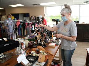 Volunteer Shelley Dietz arranges jewellery at the Pet Save ReTail Thrift Store on Notre Dame Avenue.