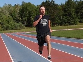 Sprinter Logan Spicer, 18, of Lo-Ellen Knights, trains at the track at Laurentian University in Sudbury, Ont. on Friday May 28, 2021. Spicer has committed to the Guelph track program. John Lappa/Sudbury Star/Postmedia Network