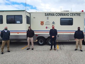 CAER's Vince Gagner (left) stands with Sarnia emergency management and corporate security officials Les Jones, Ron Realesmith and Carson Wilson. A new mobile command vehicle is being built to replace a nearly 30-year-old retrofitted recreational vehicle. Handout
