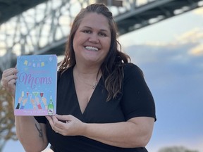 Sarnia's Mary O'Hora poses with her new book by the Blue Water Bridge. Handout