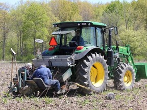 Jim Gould and Stu Sharp are shown planting trees at Fairbank Oil Fields in Oil Springs earlier this month, as Wally Van Dunn slowly drives the tractor forward. The reforestation project between Fairbank Oil and the St. Clair Region Conservation Authority included planting 13,370 trees in 2020 and 2021. Submitted