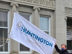 A flag raising was held at city hall on Monday as Timmins Mayor George Pirie proclaimed May as Huntington Disease Awareness Month. In addition to the flag raising, the McIntyre headframe will be lit up for the #LightItUp4HD campaign. Due to COVID restrictions, the group is holding a virtual walk at the end of May to raise funds and awareness.