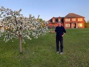 Grant Brown with one of the many trees planted.