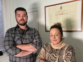 York Regional Police Const. Chris Vandenbos and Toronto Police Sgt. Julie Evans, who are among the 15 active officers and four retirees taking the government and their police forces to court, stand in front of the Charter of Rights in Toronto on May 3, 2021.