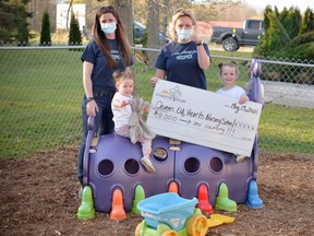 Lisa Campbell, left, and Amy McConachie of the Residential Hospice of Grey Bruce with Rhea and Reese, granddaughters of Charlene Montgomery, at the Queen of Hearts nursery school in Balmy Beach. The nursery school has raised over $18,000 through their Hike for Hospice fundraiser in the memory of Montgomery, who worked there before she died of cancer last year.