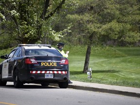 Oxford OPP officers were at The Bridges in Tillsonburg golf course Friday, taking notes and snapping photos of golfers. The golf course was charged Thursday night under the Reopening Ontario Act for violating the province's lockdown orders.

KATHLEEN SAYLORS/SENTINEL-REVIEW