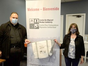 Fanny Belcoski, right, and Rev. Peter Ciallella inside the newly opened Centre for Migrant Worker Solidarity in Simcoe, a resource centre and gathering spot for migrant farm workers in Norfolk County. Among the centre's first projects is to fill and distribute welcome bags filled with toiletries, snacks and personal protective equipment, as well as information about workers' employment and health rights. J.P. Antonacci, Local Journalism Initiative Reporter