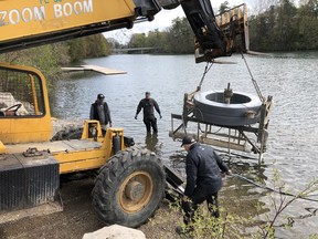 Tillsonburg Kinsmen Club members Cedric Tomico and Peter Braun of 360 West offered the use of their large material handler for the task of lifting the Lake Lisgar fountain into the water Saturday morning. (Contributed photo)