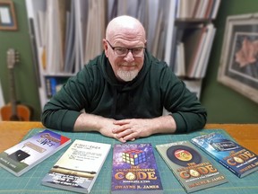 Dwayne James shows off the many books that he has written. He has a few more in his “Code” series.TP.jpg