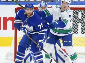 Toronto Maple Leafs' T.J. Brodie (78) defends in front of the net with Vancouver Canucks' Brock Boeser (6) during the second period in Toronto on April 29. Jack Boland/Toronto Sun/Postmedia Network