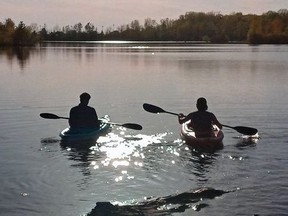 Kole Babcock, right, and Tom Grignard set out in their kayaks Tuesday on Lake Margaret after city council approved non-motorized boating, as well as fishing at the flooded former gravel pit. (Eric Bunnell photo)