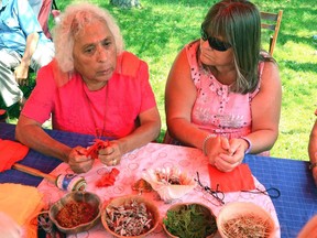 Anishinaabeg elder Shirley John, left, shown in this file photo, held workshops Saturday during an event to celebrate the completion of Phase 1 of the Giche Namewikwedong Reconciliation Garden at Kelso Beach Park. Lori Joy of Owen Sound, seated next to John, said she came to learn more about First Nations' traditions. Denis Langlois/Post Media Network