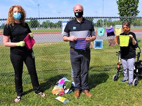 Mayor Mitch Panciuk gathered Wednesday with Julie Maisonneuve, right, and Shari Maracle of CNIB Deafblind Community Services for the unveiling of Belleville’s very own “yarn bomb” installation at the Mary Anne Sills track. CITY OF BELLEVILLE