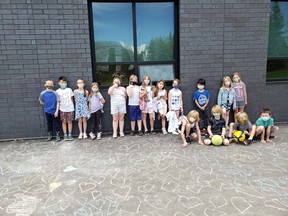 On Wednesday, June 2, Heritage Hills Elementary's Mrs. Wujcik's Grade 2 class etched 215 chalk hearts outside of the school to honour the 215 children's unmarked graves found at a former Kamloops Residential School. Photo courtesy Twitter/@Amanda26894232