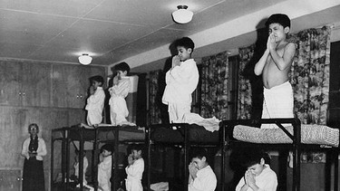 Children say prayers at an unidentified residential school.