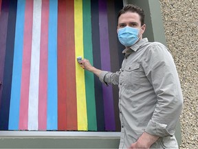 To mark Pride Month, three flags — Pride Progress, Trans Flag, and Bisexual Pride, have been painted on the public-facing windows of the Strathcona County Museum and Archives. Lindsay Morey/News Staff