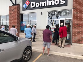 Line-ups of people waited patiently – and socially-distanced – May 29 at Domino’s Port Elgin to pick up their pizzas. A donation of $5 per pizza will be made by Domino's to the family of the late Jose Coronado, a Hi-Berry Farm Mexican worker who died of natural causes in April in Port Elgin. [Supplied]