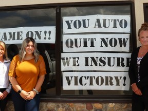 Grigg Insurance brokers Abby McKillop, Shayden Lasher and Heidi Adams hit the battleground in the Mayerthorpe sign war.