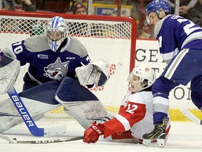 Sudbury Wolves goaltender Mitchell Weeks (70) and defenceman Emmett Serensits (27) look to foil a scoring chance by Soo Greyhounds forward Tye Kartye (12) during third-period Ontario Hockey League action at GFL Memorial Gardens in Sault Ste. Marie, Ontario on Saturday, December 28, 2019. Serensits was Sudbury's first-round pick in the inaugural OHL Under-18 Priority Selection in 2017, while Weeks was their first-round choice in the 2018 edition of the draft.