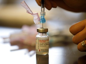 Nurse Brenda Lotakoun draws a dose of the Moderna COVID-19 vaccine March 23 in Toronto.