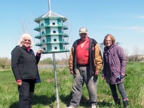 Anne Melady (left), Bert Vorstenbosch, Sr. and Rita Christie are seen with a purple martin house they erected at the West Perth Wetlands last month. SUBMITTED