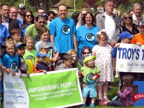 Troy and Annette Chandler (centre) gather with supporters during a pre-pandemic Troy’s Trail fundraiser. Supplied