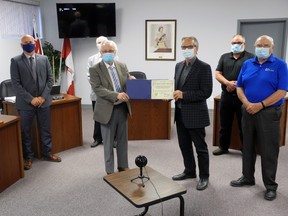 Edswardsburgh Cardinal welcomes industrial park expansion. With council members in the background, Mayor Pat Sayeau (left) presents a certificate to Prysmian's John Edwards after council approves site plan amendment. Wayne Lowrie/Recorder and Times