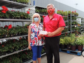 John Satosek, owner of Canadian Tire presents the cheque for $5,506 to Jeanne Lindsay, Auxiliary member. SUBMITTED