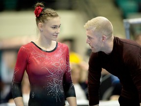 Emma Spence confers with coach Denis Vachon during the Canadian Gymnastics Championships in Waterloo.