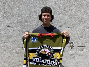 Elliott Haigh holds up his new Voodoos hockey jersey.  
Powassan Voodoos Photo