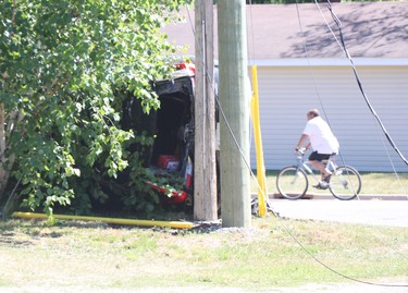 A cyclist rides by following a collision near Boundary Road and South Market Street on Friday, June 18, 2021. (BRIAN KELLY/THE SAULT STAR/POSTMEDIA NETWORK)