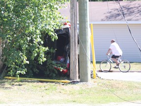 A cyclist rides by following a collision near Boundary Road and South Market Street on Friday, June 18, 2021. (BRIAN KELLY/THE SAULT STAR/POSTMEDIA NETWORK)