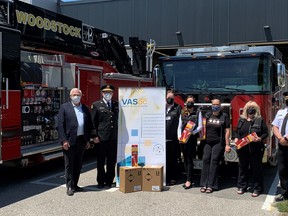 Volunteers and officials from Victim Assistance Services of Oxford, with members of the Woodstock Fire Department and Oxford MPP Ernie Hardeman met for a photo following a fire department donation of 40 portable fire extinguishers. (Victim Assistance Services of Oxford County)