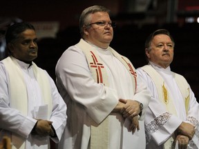 Rev. Ignatius Xavier (left), Rev. Pat Woods and Rev. Hamish Currie attend a mass for Catholic high school students at Essar Centre in Sault Ste. Marie, Ont., on Wednesday, May 7, 2014. (BRIAN KELLY/THE SAULT STAR/QMI AGENCY)