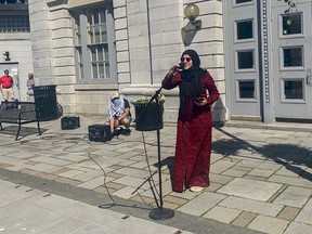 Yara Hussein, coordinator of the Palestine Protest, stands in Springer Market Square, behind City Hall, in Kingston, Ont., on Sun., June 20. Hussein addressed the need for the federal government to stop funding war crime in Israel. Sydney Ko for the Kingston Whig-Standard/Postmedia Network.