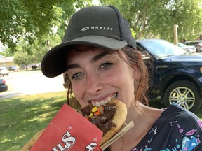 Ivy Farrell, of Ripley, enjoys her Beaver Tail after work. Farrell hadn't eaten a Beaver Tail since she was a child and was excited to see them in Lucknow on Saturday, June 12. Hannah MacLeod/Lucknow Sentinel